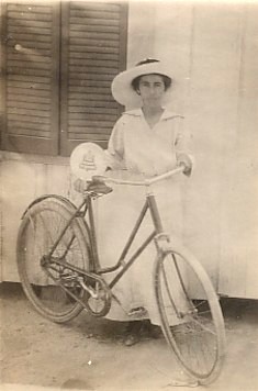 This great real photo postcard image of a young Southern woman with a very vintage bicycle circa 1918 raises a couple of questions: Does the small sign mean that she works for "Southern Bell" or that she "is" a Southern Bell?!  Maybe she delivers telegrams?  Private Collection.
